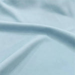 Image montrant un tissu bleu clair doux, idéal pour la décoration intérieure ou la confection de vêtements. Sa teinte pastel apporte une touche de fraîcheur et d'élégance à tout projet créatif ou aménagement de maison. Convient parfaitement pour des rideaux, des coussins ou des draperies pour une ambiance apaisante.