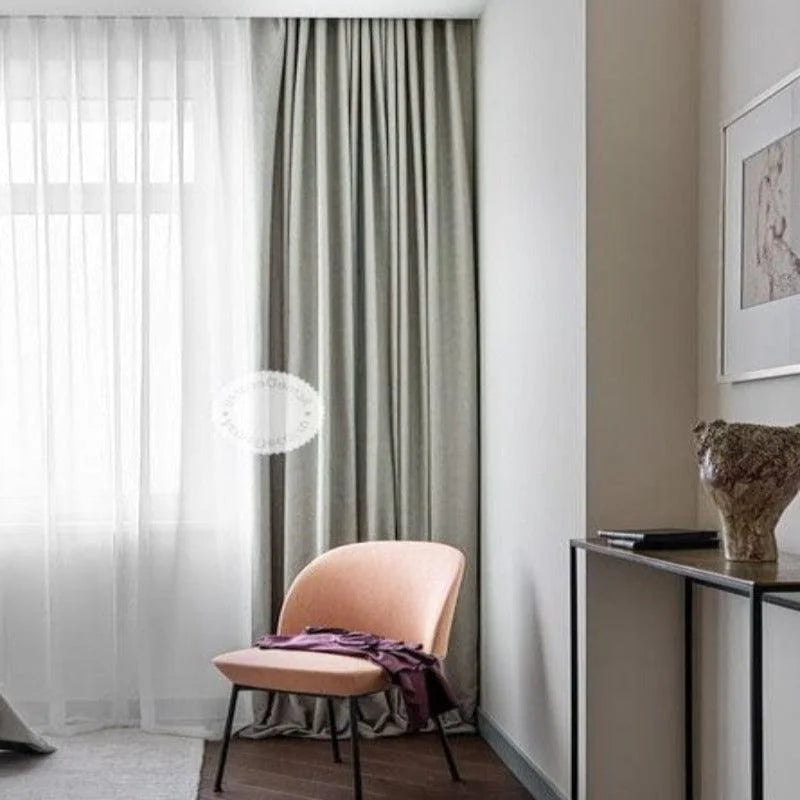 Fauteuil design moderne couleur rose dans un intérieur élégant, placé près de rideaux longs et lumineux. Idéal pour ajouter une touche contemporaine et chic à votre salon ou espace de lecture, ce fauteuil se marie parfaitement avec une décoration minimaliste.