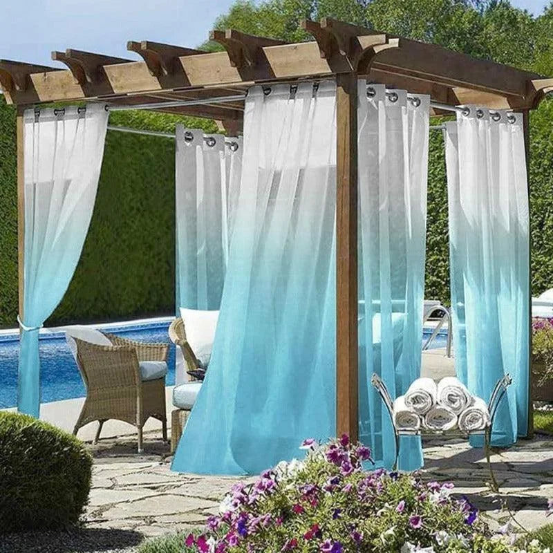 Pergola élégante avec rideaux dégradés dans un jardin, créant un espace ombragé et moderne près de la piscine. Idéale pour se détendre et profiter de l'extérieur. Aménagement de jardin avec fleurs et mobilier confortable pour des moments de convivialité estivale.