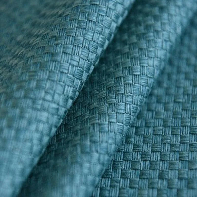 Texture en tissu bleu avec un motif en damier, idéale pour la décoration intérieure et la confection de meubles modernes. Cette étoffe offre une touche d'élégance et de sophistication à tout espace.
