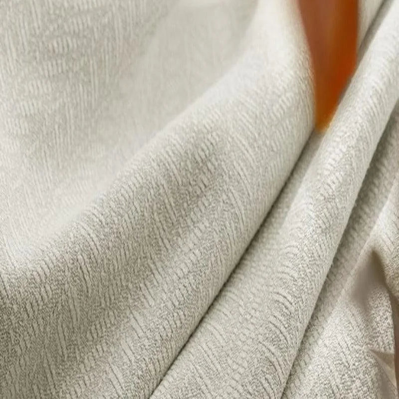 Textile beige avec texture subtile en relief, idéal pour décoration intérieure moderne et élégante. Parfait pour confectionner des rideaux ou recouvrir des meubles, ajoutant une touche de sophistication à tout espace.