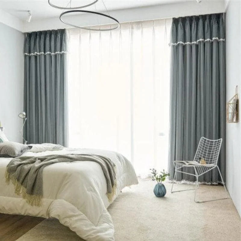 Chambre moderne avec rideaux opaques gris offrant une ambiance apaisante. Chambre à coucher lumineuse dotée d'une grande fenêtre et d'un lit confortable. Espace de vie élégant avec décoration épurée et chaise design. Parfait pour améliorer l'intimité et le confort de votre intérieur. Idéal pour un style contemporain et cosy.