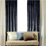 Rideaux élégants gris foncé et crème encadrant un canapé beige avec coussins décoratifs variés, idéal pour une décoration de salon sophistiquée et moderne.