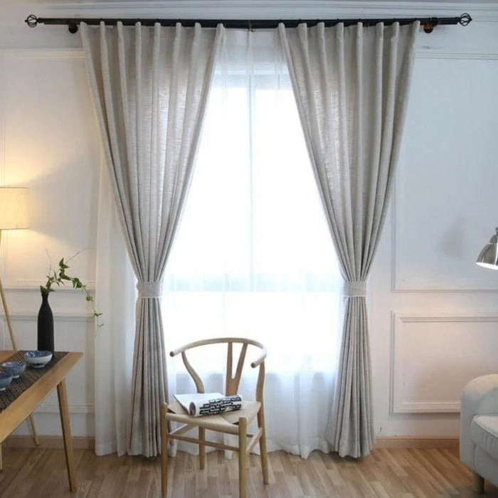 Rideaux élégants pour salon moderne, coloris neutre, offrant une ambiance lumineuse et chaleureuse. Accessoire de décoration intérieure idéal pour filtrer la lumière naturelle tout en préservant l'intimité. S'intègre parfaitement avec des meubles en bois clair pour un style scandinave sophistiqué.