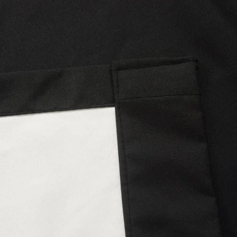 Housse de coussin carrée noire et blanche avec coutures visibles pour un design moderne et élégant, accent idéal pour la décoration intérieure contemporaine.