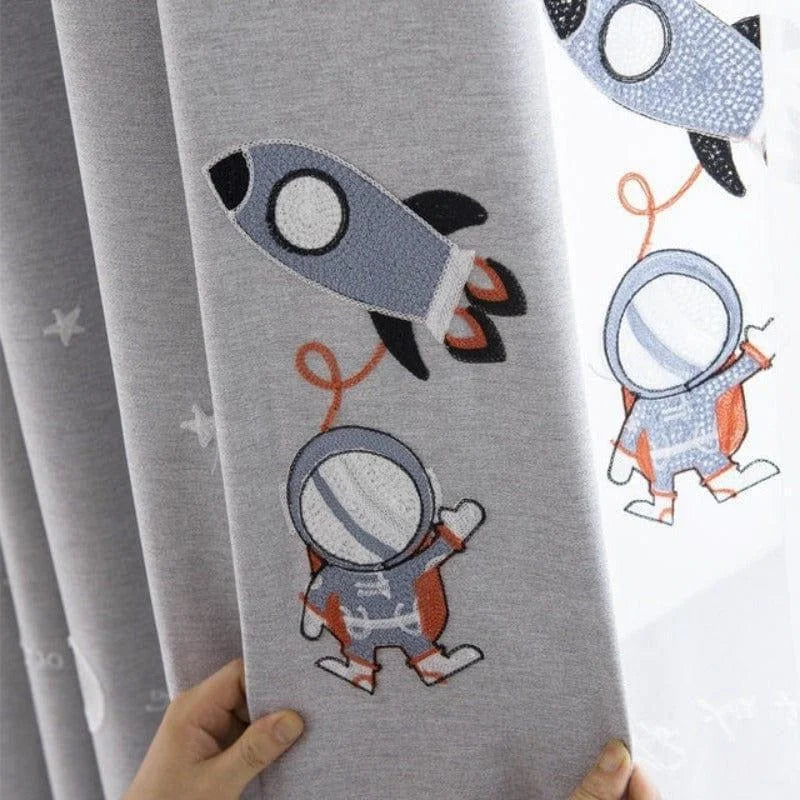 Rideau gris pour chambre d'enfant avec motifs d'astronaute et fusée. Décoration ludique et colorée idéale pour stimuler l'imagination des petits. Accessoire parfait pour créer une ambiance spatiale dans un intérieur moderne et accueillant.