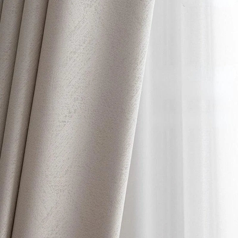 Rideau élégant gris clair devant une fenêtre, parfait pour ajouter une touche moderne et sophistiquée à votre intérieur. Idéal pour le salon ou la chambre à coucher, ce rideau offre une décoration subtile et raffinée tout en filtrant la lumière naturelle.