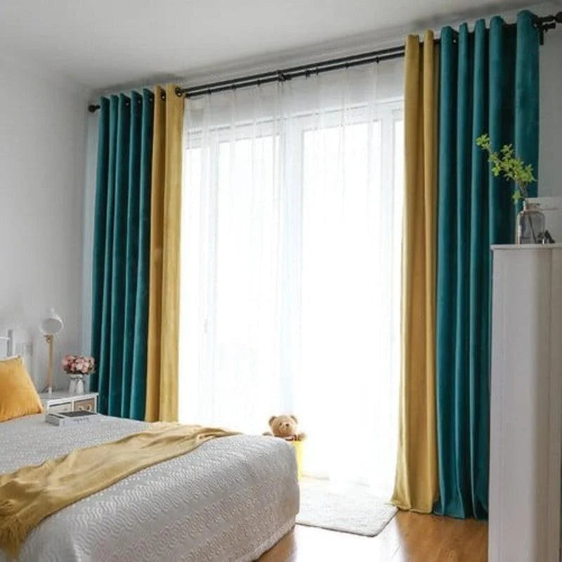 Chambre contemporaine avec rideaux bleu canard et jaune, offrant une ambiance lumineuse et élégante. Les rideaux encadrent une grande baie vitrée, laissant entrer une lumière naturelle abondante. La décoration intérieure est complétée par un lit avec des draps assortis et des accessoires de décoration modernes. Parfait pour ajouter une touche de couleur et de sophistication à votre espace de vie.