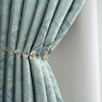 Rideau élégant bleu avec motif géométrique, attaché avec une embrasse décorative ornée de détails perlés. Idéal pour ajouter une touche raffinée à votre intérieur et filtrer délicatement la lumière dans votre salon ou chambre. Parfait pour les décors modernes à la recherche de style et de fonctionnalité.