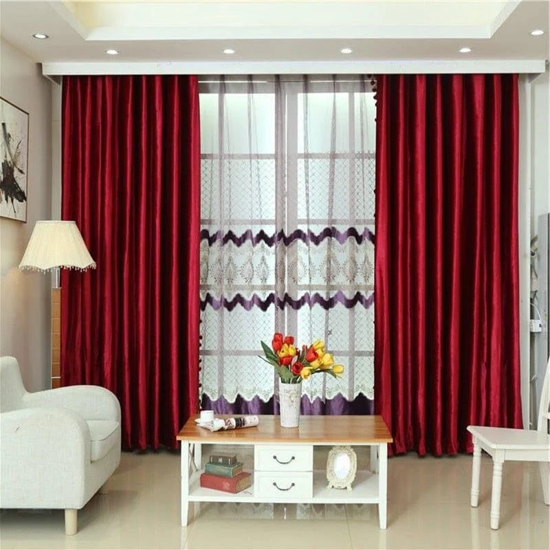 Rideaux rouges élégants pour salon moderne, apportant une touche chaleureuse et sophistiquée à la décoration intérieure. Ils encadrent une grande fenêtre, complétant harmonieusement le mobilier lumineux et accentuant le style contemporain de la pièce.