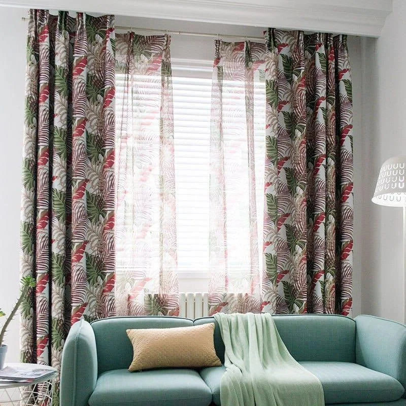 Rideaux à motif tropical coloré devant une fenêtre avec stores vénitiens. Décoration intérieure mettant en avant un canapé bleu clair et un coussin assorti dans un salon moderne et lumineux. Atmosphère apaisante et élégante, soulignée par une lampe au design minimaliste. Idéal pour ajouter une touche de nature et de style à votre espace de vie.