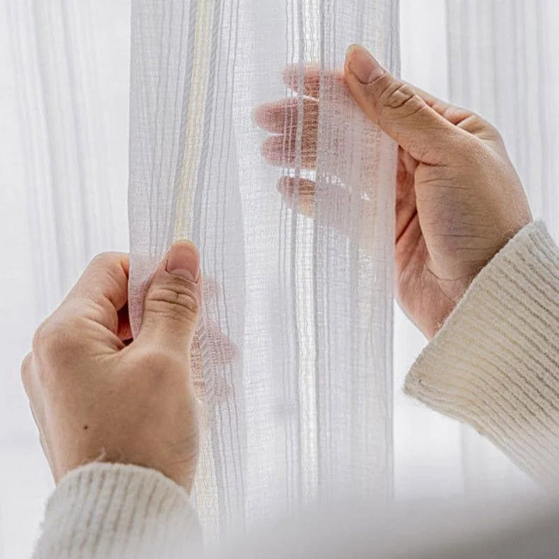 Voilage transparent délicat en blanc, idéal pour apporter une touche de légèreté et d'élégance à votre intérieur. Parfait pour diffuser une lumière douce dans toutes les pièces de la maison. Style moderne et épuré pour une décoration raffinée.