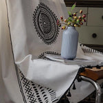 Image d'un élégant vase côtelé bleu clair posé sur un livre, entouré d'un tissu au design mandala noir et blanc, idéal pour rehausser la décoration intérieure avec une touche artistique et moderne. Parfaite harmonie entre éléments décoratifs contemporains et classiques, convie une ambiance apaisante et stylisée à votre espace de vie.