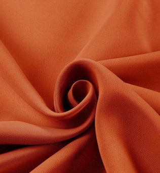 Tissu de couleur orange vif élégant, texture douce et fluide, parfait pour la confection de vêtements tendance et modernes.