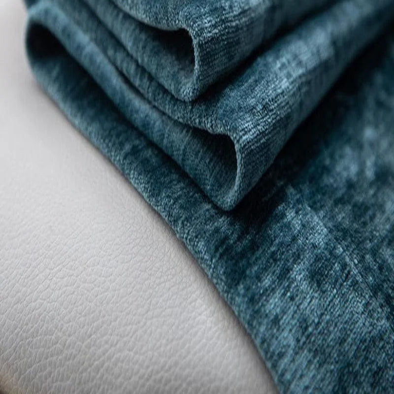 Tissu bleu texturé plié soigneusement sur une surface claire, idéal pour la décoration intérieure et l'ameublement. Accessoire tendance pour sublimer votre espace de vie avec élégance et modernité.