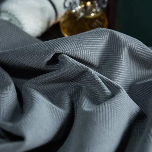 Étoffe grise texturée avec motif à chevrons, idéale pour la confection de vêtements élégants. Le design subtil ajoute une touche de sophistication et de modernité à toute création. Parfait pour l'habillement formel ou les accessoires de mode raffinés.