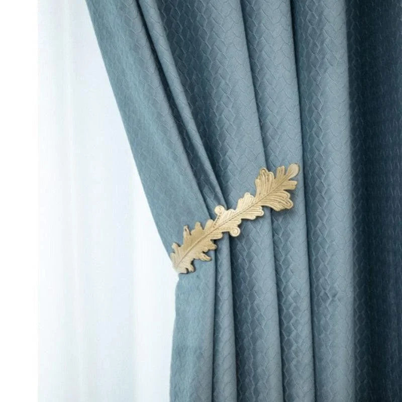 Rideau élégant bleu avec embrasse décorative dorée en forme de feuille de chêne. Idéal pour ajouter une touche raffinée à votre intérieur. Convient parfaitement aux salons, chambres ou bureaux pour une décoration contemporaine et chic.