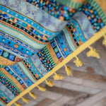 Élégant tapis aux motifs géométriques colorés, ornés de franges jaunes, idéal pour ajouter une touche vibrante et artistique à votre intérieur. Parfait pour apporter chaleur et style à votre espace de vie.