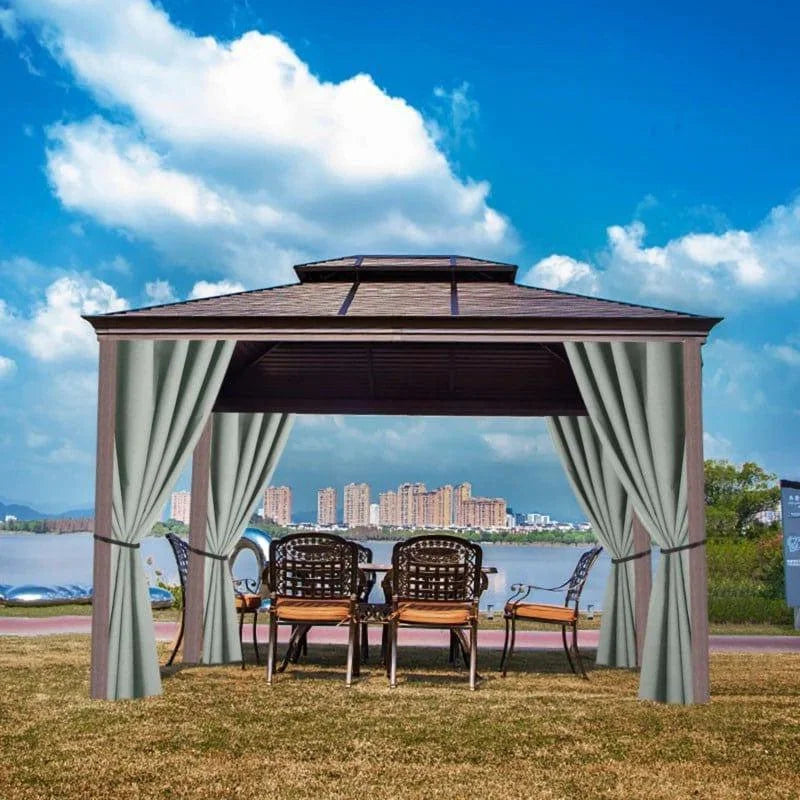 Pavillon de jardin élégant avec toit en pente, équipé de rideaux pour une protection solaire optimale. Ce kiosque spacieux est idéal pour créer un espace détente ou pour recevoir des invités dans votre jardin. Aménagement extérieur parfait pour profiter des journées ensoleillées avec vue sur un lac et la ville en arrière-plan. Le pavillon est complété par un ensemble de meubles de jardin confortables.