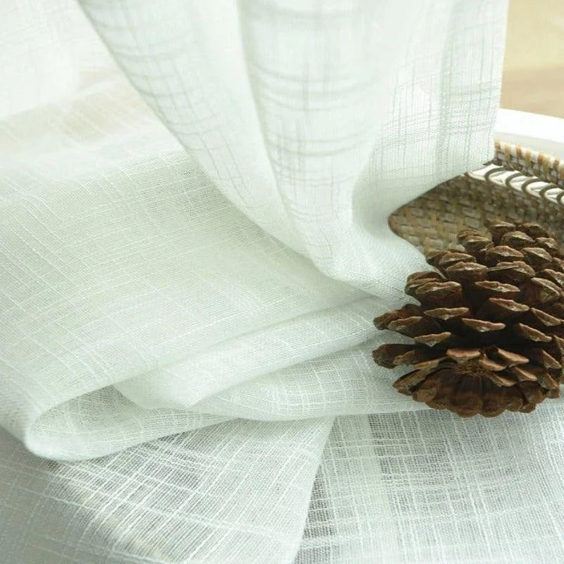 Voilage élégant blanc pour décoration intérieure, parfait pour ajouter une touche de légèreté et de sophistication à votre salon ou chambre. Accessible et facile à intégrer dans différents styles de décoration.