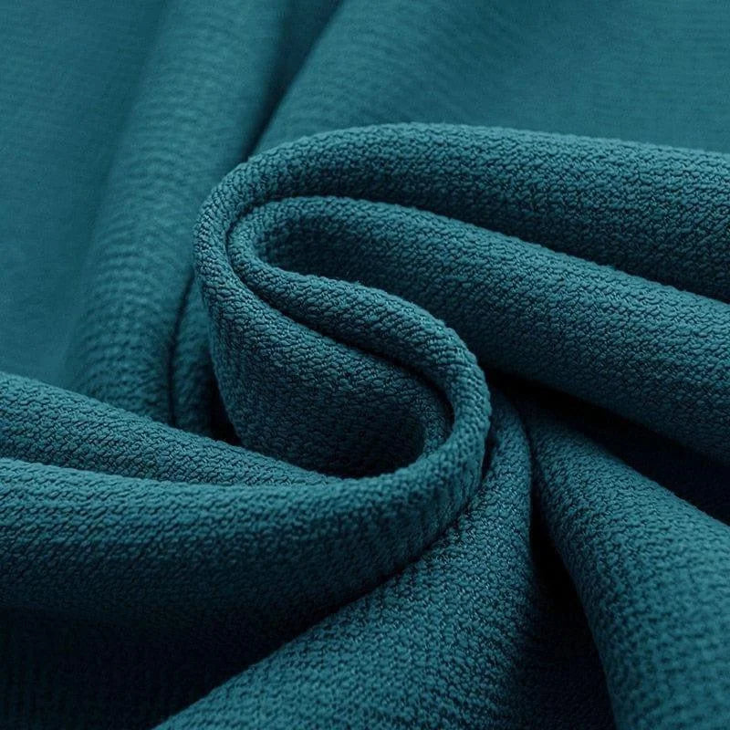 Tissu bleu pétrole texturé, offrant un design élégant et contemporain, idéal pour la décoration intérieure et les projets de couture créatifs.