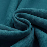 Tissu bleu pétrole texturé, offrant un design élégant et contemporain, idéal pour la décoration intérieure et les projets de couture créatifs.