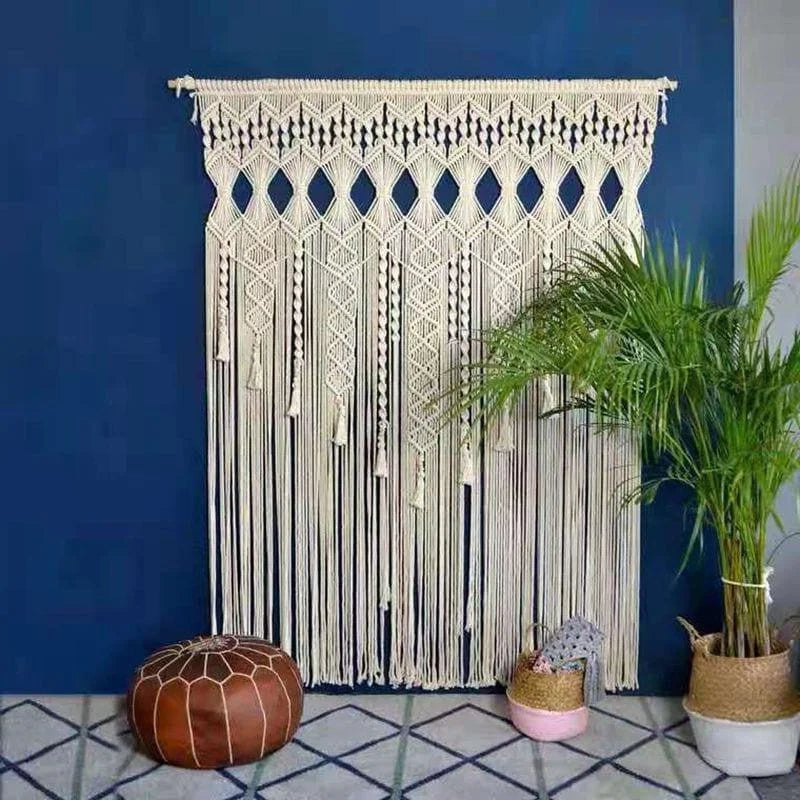 Décoration murale bohème avec motifs géométriques suspendue dans un intérieur moderne. Ambiance cosy avec une plante verte en pot et un pouf décoratif sur un sol aux motifs géométriques. Parfait pour ajouter une touche artistique et chaleureuse à votre espace de vie.