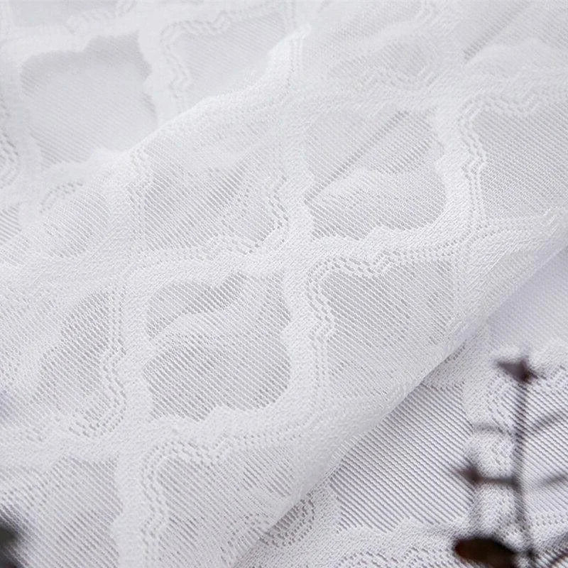 Voile blanc avec motif géométrique, élégant et raffiné, parfait pour la décoration intérieure de fenêtres ou comme élément de séparation décoratif dans une pièce moderne.