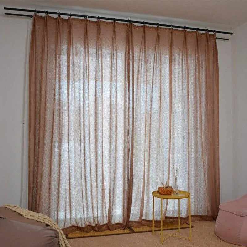 Rideaux transparents beiges élégants pour salon, offrant une lumière douce et tamisée. Parfaits pour une décoration intérieure moderne, ces voilages créent une ambiance chaleureuse et accueillante. Idéal pour ajouter une touche de sophistication à votre espace de vie tout en maintenant votre intimité.