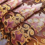 Tissu décoratif luxueux avec motifs floraux brodés en or et rose, idéal pour la confection de rideaux élégants et de vêtements sophistiqués. Design artistique et détails raffinés apportant une touche de charme et d'élégance à tout intérieur. Parfait pour embellir votre espace avec sophistication.