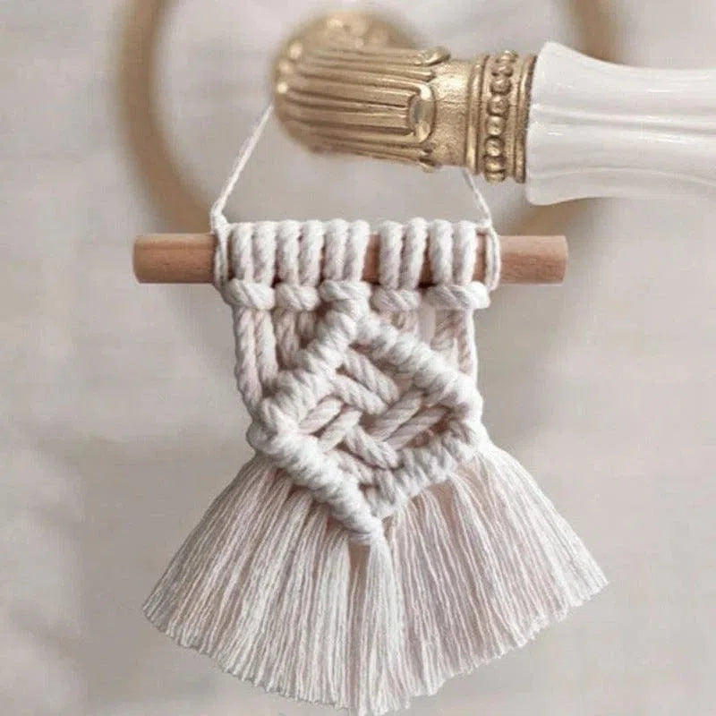 Décoration murale en macramé artisanale, accroché à un support élégant dans un intérieur moderne. Design bohème chic, idéal pour ajouter une touche artistique et chaleureuse à votre espace de vie. Accessoire décoratif parfait pour les amateurs de tendances naturelles et minimalistes.