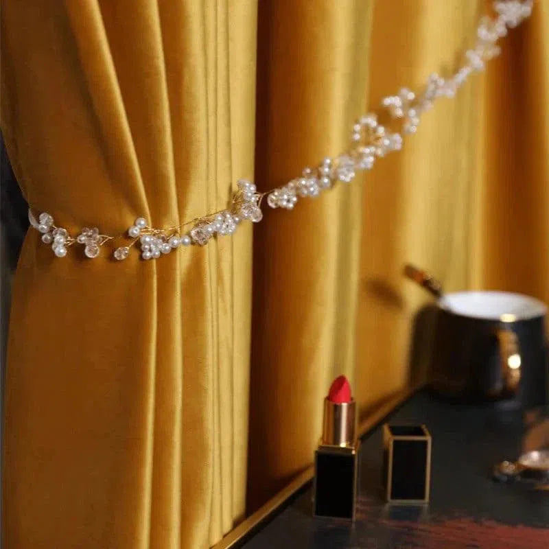 Rideau élégant de couleur dorée rehaussé d'une attache ornée de perles translucides, parfait pour ajouter une touche sophistiquée à votre intérieur. Idéal pour les salons modernes cherchant à allier esthétisme et fonctionnalité. Apportez une ambiance chaleureuse et chic à votre pièce avec cet accessoire de décoration raffiné.