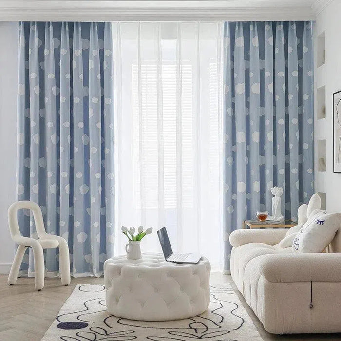 Rideaux bleus à motifs pour salon moderne, apportant une touche élégante et lumineuse à votre intérieur. Ils encadrent une fenêtre large, permettant une diffusion douce de la lumière naturelle. Parfait pour un aménagement contemporain et accueillant.