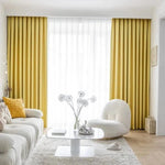 Salon moderne avec rideaux jaunes élégants, illuminant la pièce de manière harmonieuse. Décoration intérieure sophistiquée, alliant confort et style. Idéal pour une ambiance conviviale et accueillante.