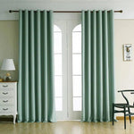 Rideaux élégants de couleur vert clair pour décoration intérieure, installés dans un salon lumineux, complètent élégamment une baie vitrée, apportant une touche moderne et harmonieuse à l'espace. Accessoires parfaits pour personnaliser et rafraîchir votre intérieur avec style.