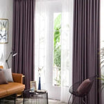 Rideau occultant moderne dans salon lumineux avec mobilier contemporain, parfait pour améliorer la décoration intérieure. Accents violets et marrons, idéale pour optimiser l'intimité et le contrôle de la lumière naturelle.