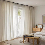 Chambre moderne avec rideaux élégants et lumineux, parfaits pour ajouter une touche de sophistication à votre intérieur. Les rideaux encadrent une grande fenêtre laissant entrer une douce lumière naturelle, idéale pour créer une atmosphère chaleureuse et accueillante. Complétez votre décoration avec des tons neutres et un mobilier en bois pour un style naturel et épuré.