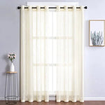 Rideau clair pour salon moderne, filtrant la lumière naturelle, accroché à une tringle noire élégante. Ambiance intérieure lumineuse et décorative, avec vue sur un cadre botanique à droite et un vase avec des fleurs à gauche. Accessoire de décoration idéal pour sublimer vos fenêtres.