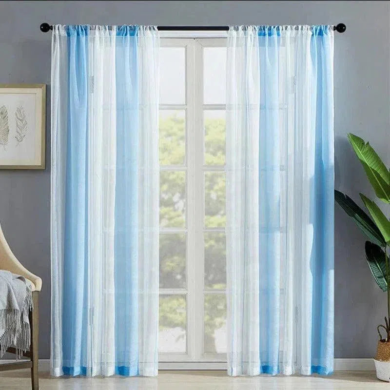 Rideaux transparents élégants, de couleur bleue et blanche, habillant une fenêtre dans un espace lumineux et moderne. Déco intérieure mettant en valeur une ambiance fraîche et apaisante, idéale pour optimiser la luminosité naturelle et apporter une touche de couleur subtile dans votre salon ou chambre. Parfaits pour un design aérien et contemporain.